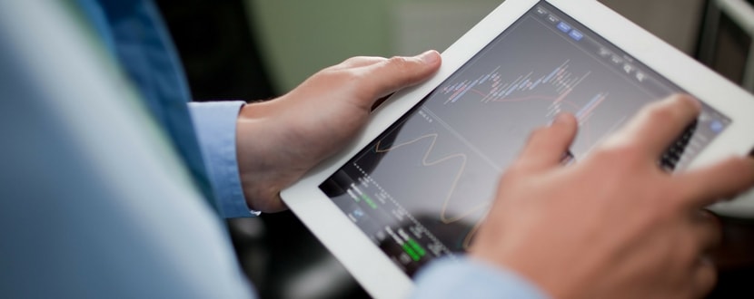person monitoring market shares via tablet - SingSaver