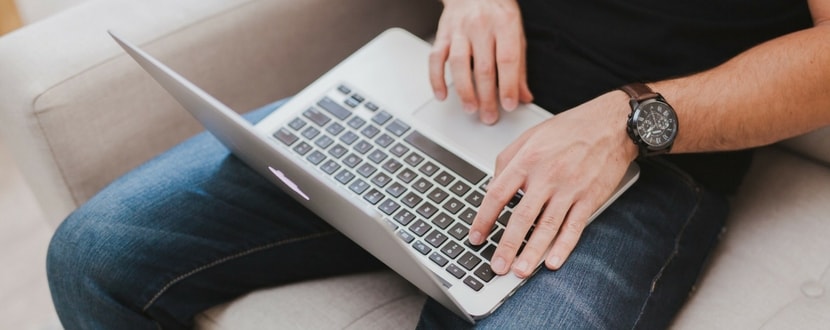 man using laptop on his lap