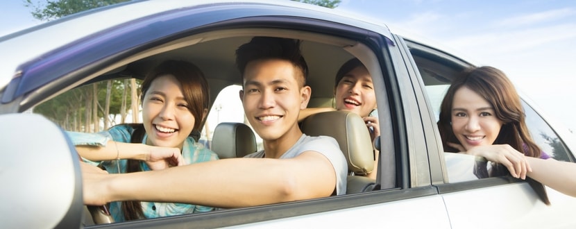 happy young adults hitching rides and car pooling