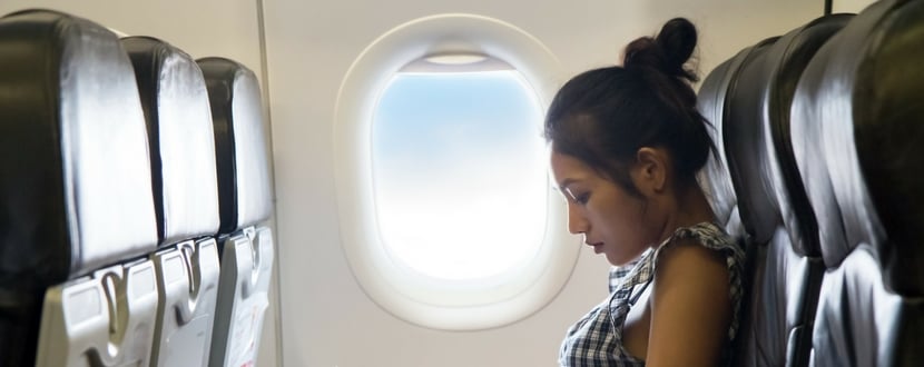 lady sitting in an airplane during flight