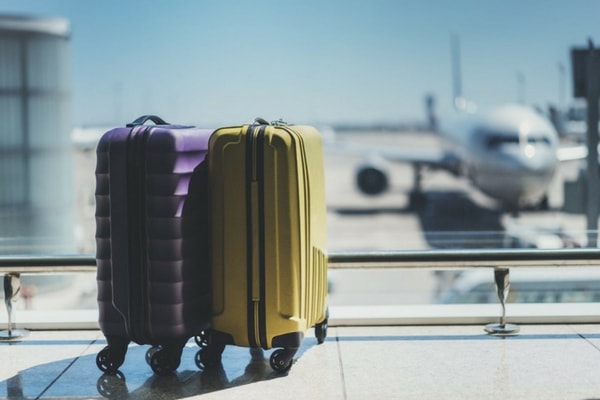 purple and yellow luggage in airport