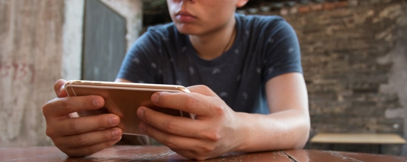 man looking at his iphone