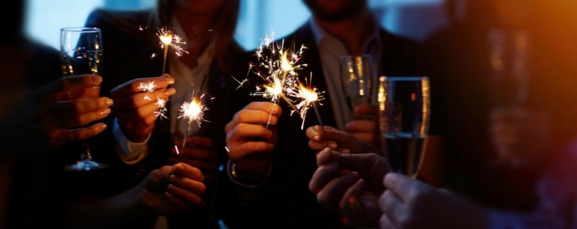 friends with fire crackers and wine glasses