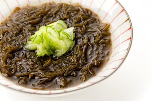 mozuku seaweed, served with sliced cucumbers