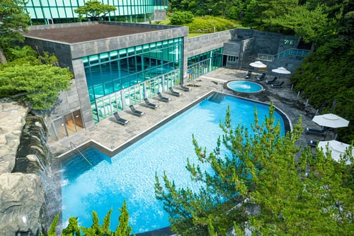 outdoor pool area at we hotel on a sunny day in jeju