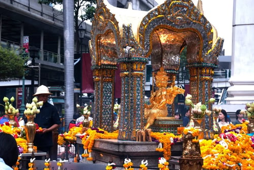 people engaging in religious activities at erawan shrine in bangkok